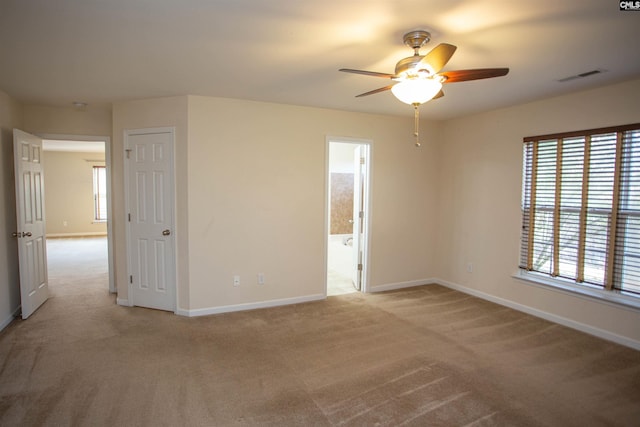 carpeted empty room featuring ceiling fan