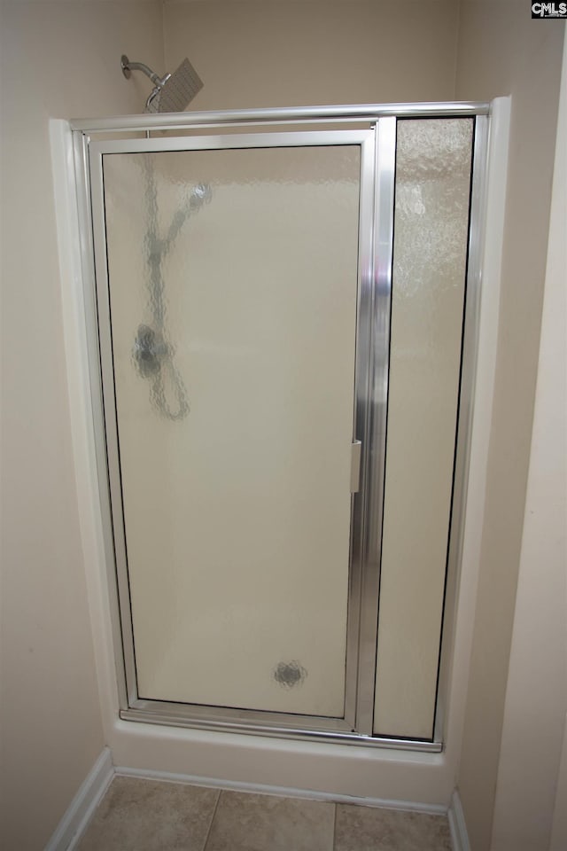 bathroom with tile patterned floors and walk in shower