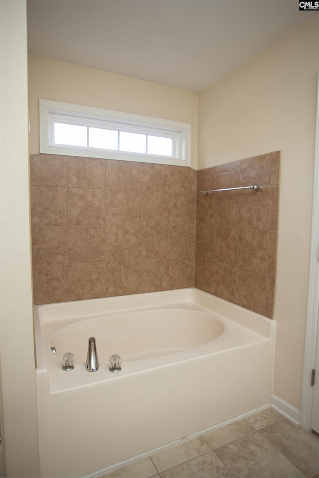 bathroom featuring tile patterned flooring and a tub