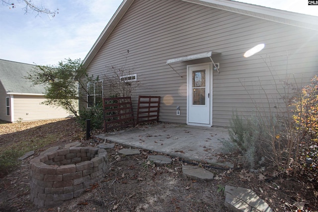 rear view of house with a patio and an outdoor fire pit