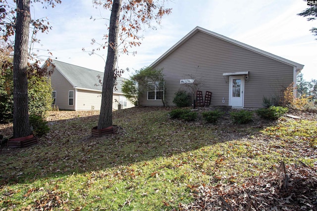 rear view of property with a yard