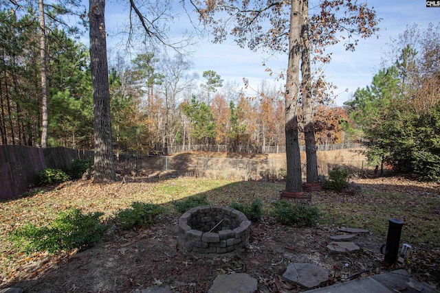 view of yard with a fire pit