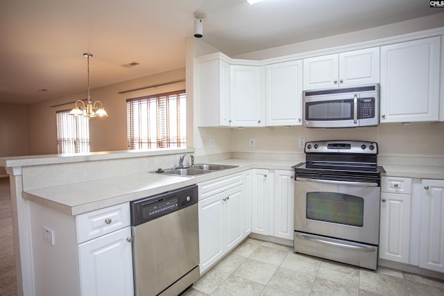 kitchen featuring kitchen peninsula, appliances with stainless steel finishes, sink, a notable chandelier, and white cabinets