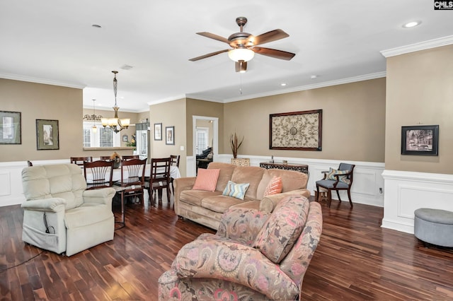 living room featuring ceiling fan with notable chandelier, ornamental molding, and dark wood-type flooring