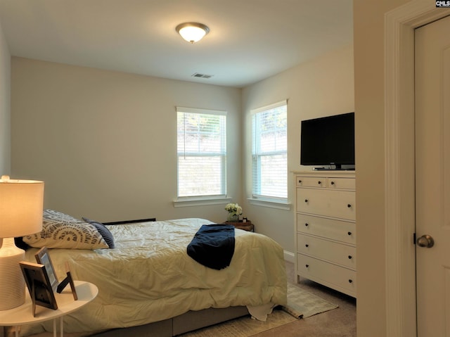 bedroom featuring light colored carpet