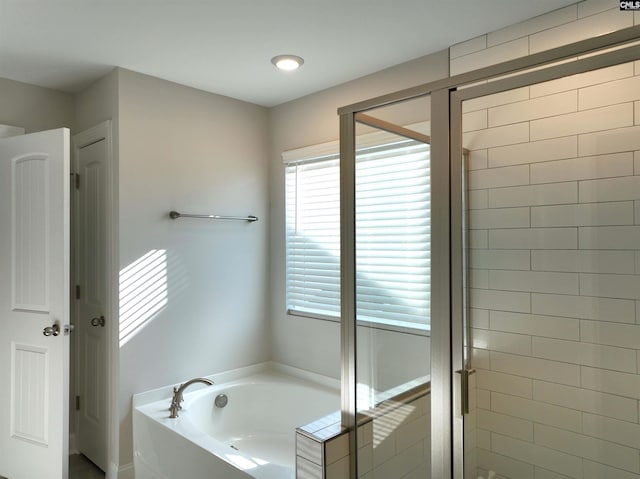 bathroom featuring separate shower and tub