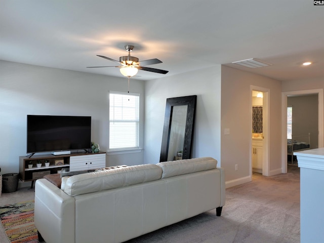 living room with recessed lighting, light colored carpet, visible vents, baseboards, and a ceiling fan