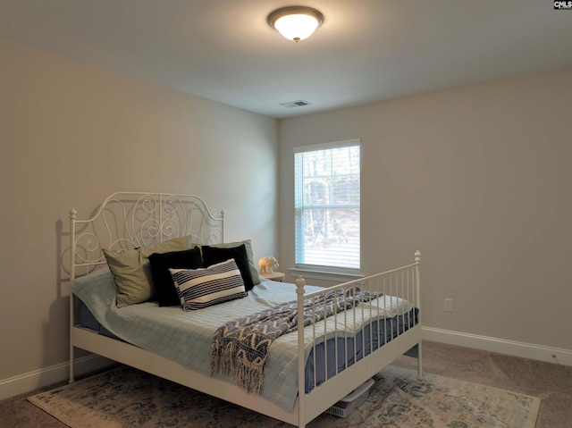 bedroom with carpet floors, visible vents, and baseboards