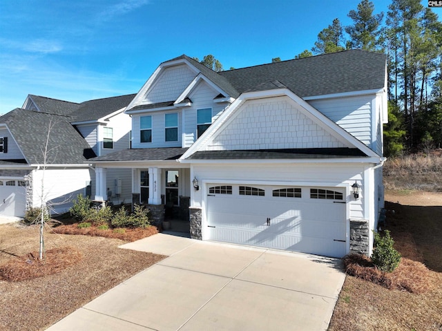 craftsman-style home with a garage, stone siding, roof with shingles, and driveway