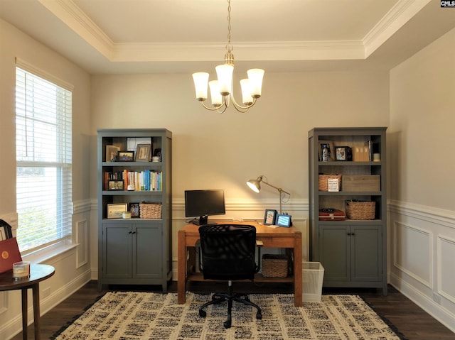 office featuring a wainscoted wall, wood finished floors, a raised ceiling, and a chandelier