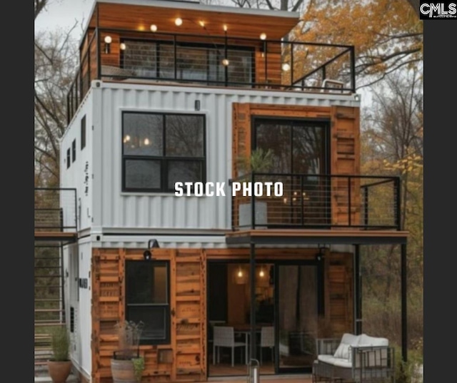 back of house with a balcony