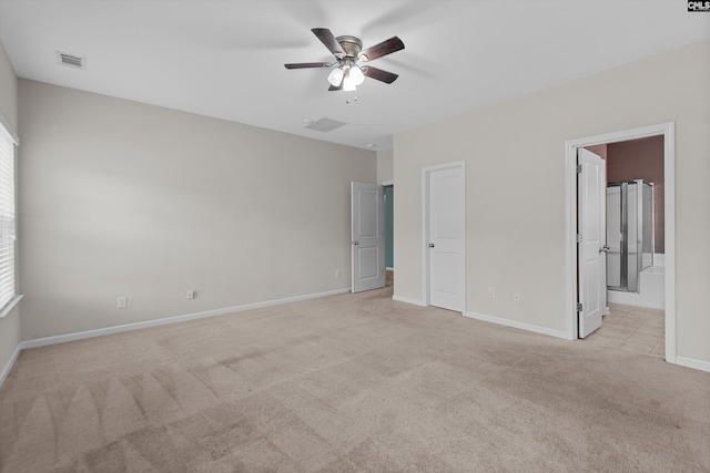 unfurnished bedroom featuring ensuite bathroom, ceiling fan, and light colored carpet