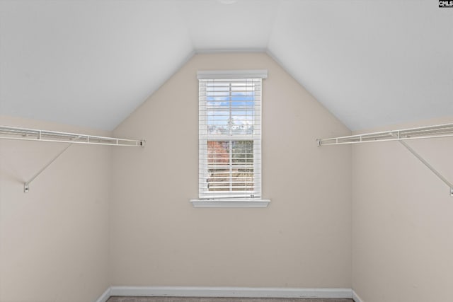 walk in closet featuring lofted ceiling