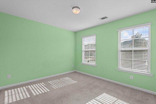 unfurnished room with light carpet