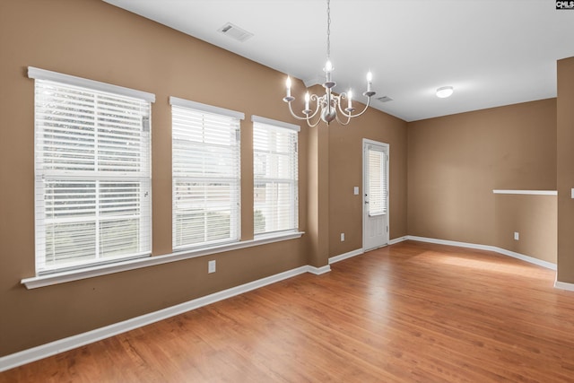 interior space featuring hardwood / wood-style flooring and a notable chandelier