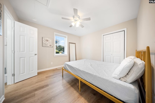 bedroom featuring ceiling fan, a closet, light hardwood / wood-style floors, and pool table