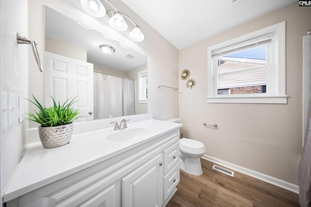 bathroom featuring hardwood / wood-style floors, vanity, and toilet