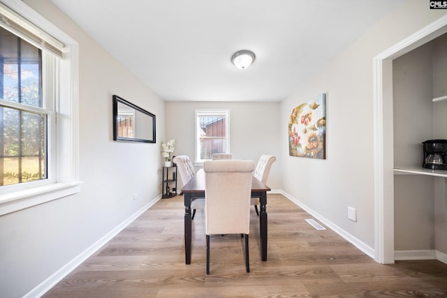 dining space with hardwood / wood-style floors