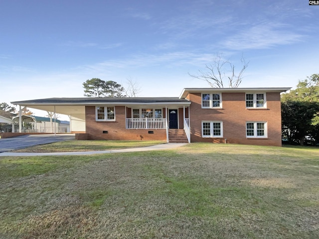 split level home featuring covered porch, a front lawn, and a carport