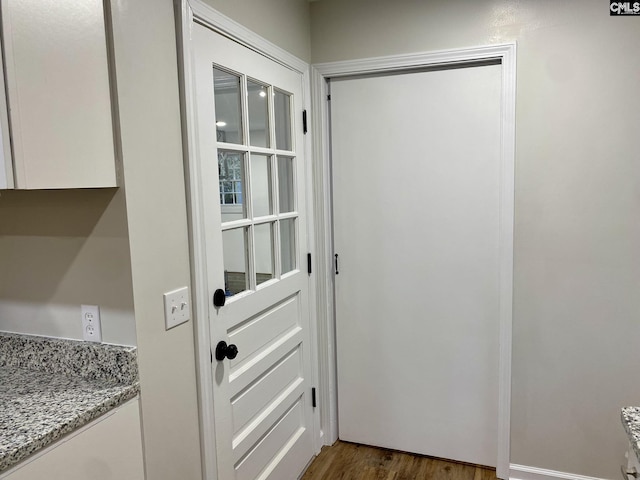 doorway to outside with dark wood-type flooring