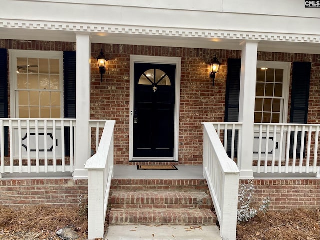 view of exterior entry with a porch