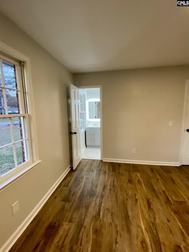 unfurnished room featuring dark wood-type flooring