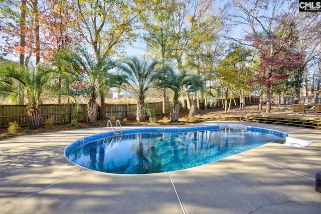 view of pool featuring a patio and a deck