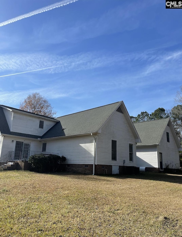 view of home's exterior with a yard