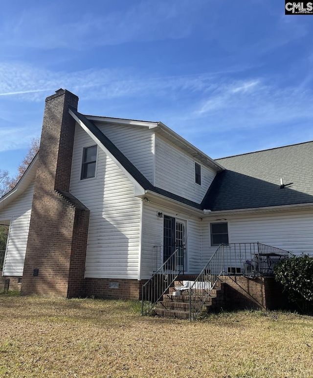 rear view of house with a lawn