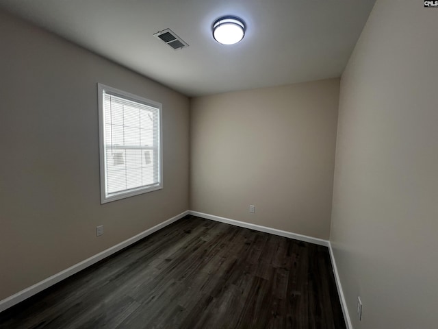 empty room with dark hardwood / wood-style floors