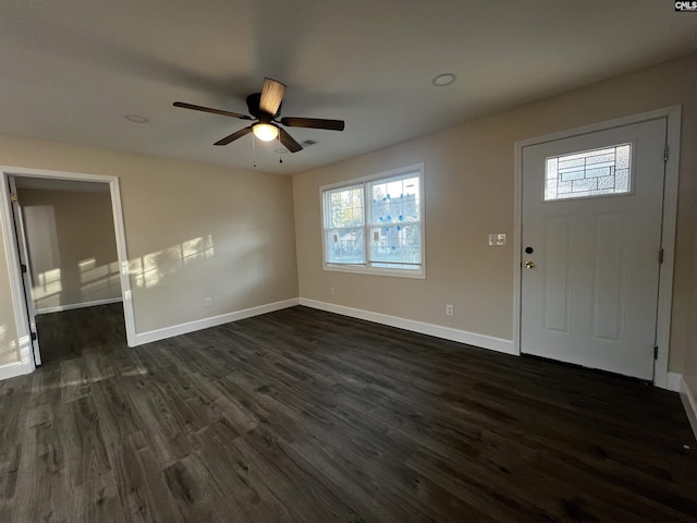 foyer entrance with ceiling fan and dark wood-type flooring