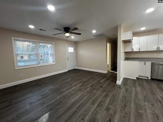 unfurnished living room with dark hardwood / wood-style flooring and ceiling fan