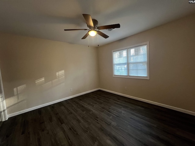 empty room featuring dark hardwood / wood-style floors and ceiling fan