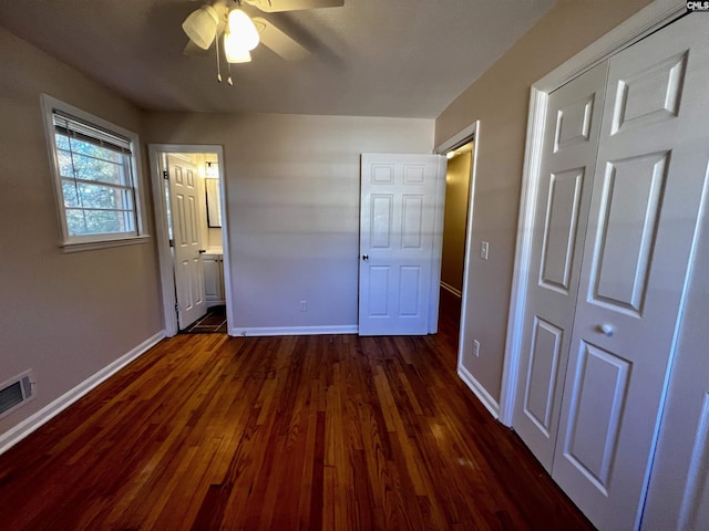 unfurnished bedroom featuring a closet, ceiling fan, dark hardwood / wood-style flooring, and ensuite bathroom