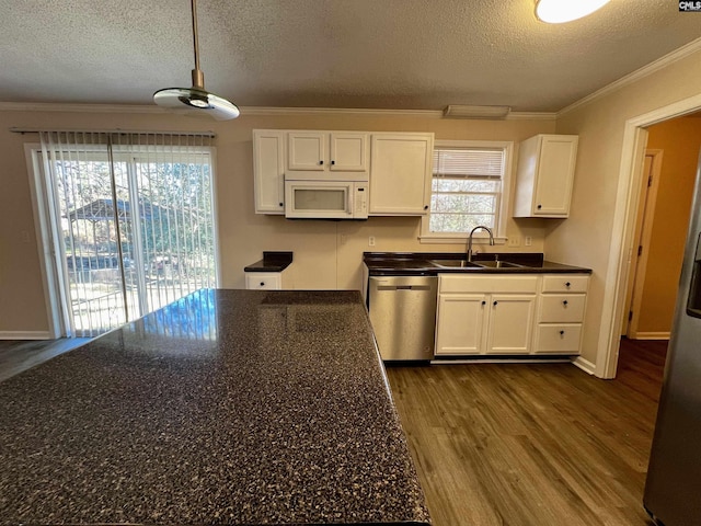 kitchen featuring ornamental molding, stainless steel appliances, pendant lighting, dark hardwood / wood-style floors, and white cabinetry