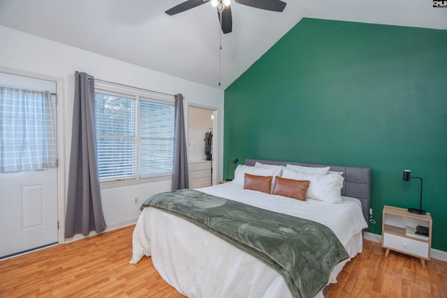 bedroom with hardwood / wood-style floors, ceiling fan, and high vaulted ceiling