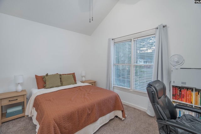 carpeted bedroom with high vaulted ceiling