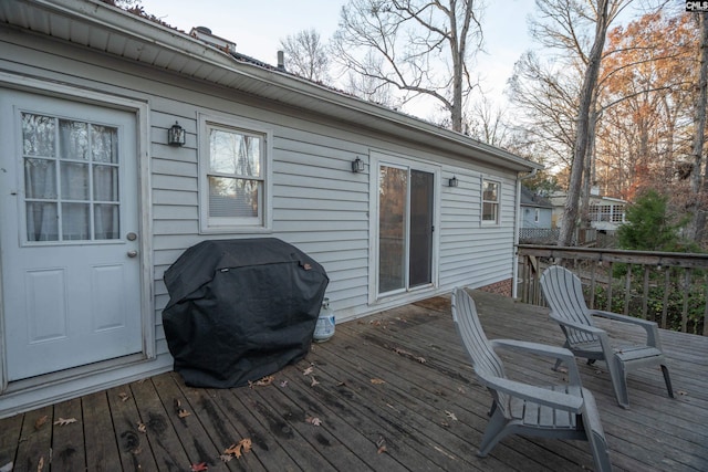 wooden terrace with a grill