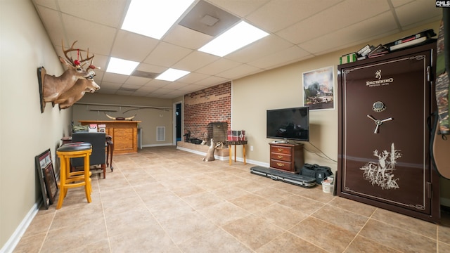 interior space featuring a drop ceiling and a fireplace