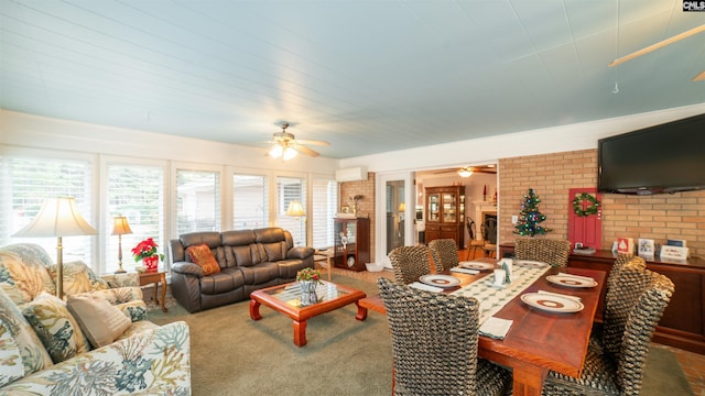 carpeted living room featuring a brick fireplace, ceiling fan, and brick wall