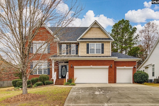 view of front of property with a front lawn, a garage, and central AC unit