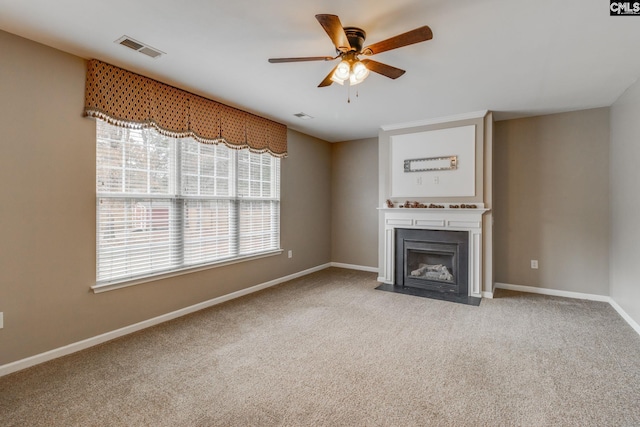 unfurnished living room with ceiling fan and light carpet