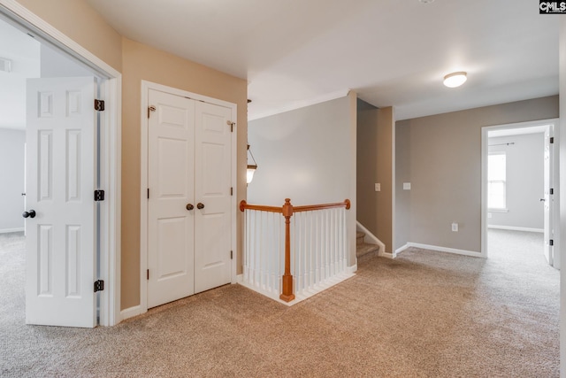 hallway with light carpet