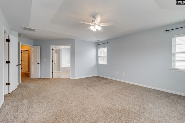 carpeted spare room with ceiling fan