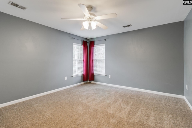 spare room featuring ceiling fan and carpet floors