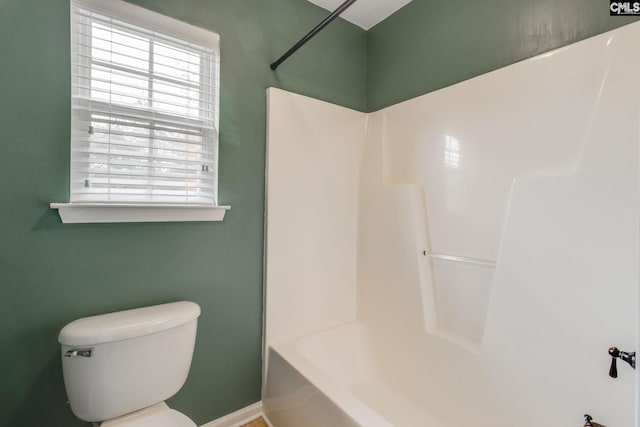 bathroom featuring shower / bath combination and toilet