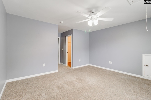 carpeted spare room featuring ceiling fan