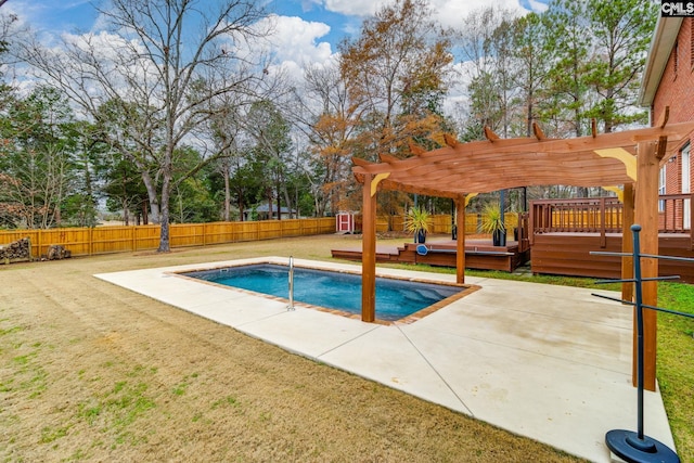 view of pool with a patio, a pergola, a deck, and a lawn