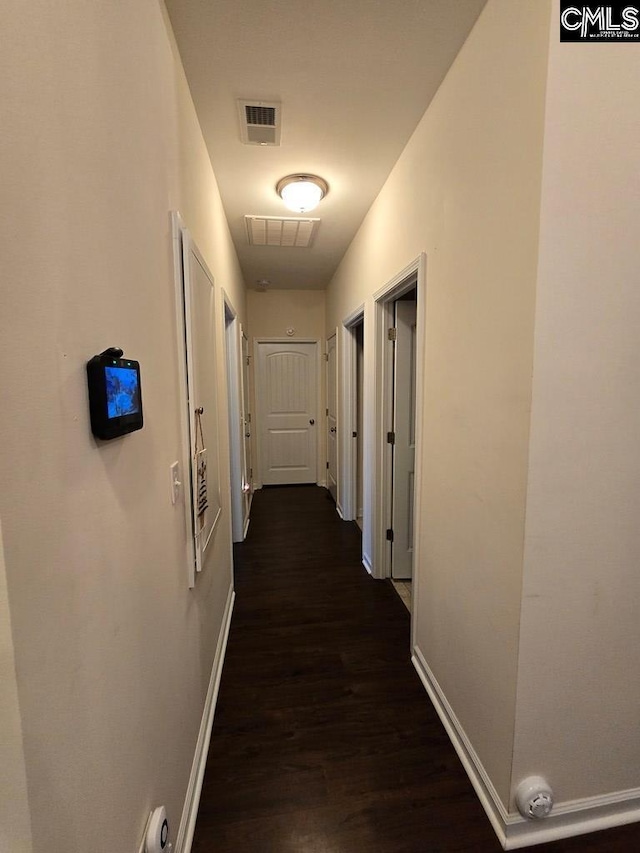 corridor featuring dark hardwood / wood-style floors