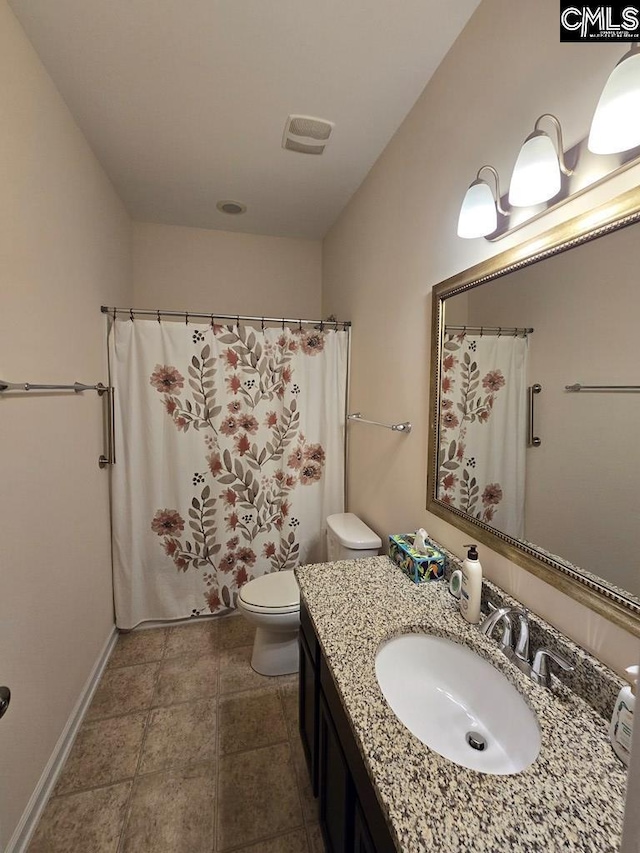 bathroom featuring vanity, toilet, and walk in shower